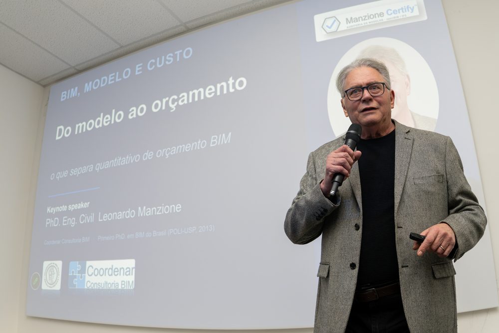 Leonardo Manzione durante palestra, ao lado do slide de abertura sobre modelo e custo